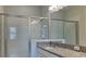 The renovated bathroom features a granite counter, stainless fixtures, glass shower doors and updated vanity at 20092 Stone Pine Cir, Lutz, FL 33558