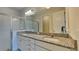 The bathroom features double sinks, granite countertop, a big mirror, and a shower cabin at 20092 Stone Pine Cir, Lutz, FL 33558