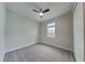 Neutral bedroom showcasing carpeted floors, ceiling fan, and one window at 20092 Stone Pine Cir, Lutz, FL 33558
