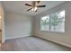 The spacious bedroom is carpeted, lit by a modern ceiling fan, and well lit with a large window at 20092 Stone Pine Cir, Lutz, FL 33558