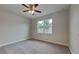 Carpeted bedroom with a ceiling fan, a large window, and neutral walls at 20092 Stone Pine Cir, Lutz, FL 33558