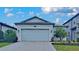 A charming one-story home with well-manicured landscaping, a two-car garage and brick paver driveway at 20092 Stone Pine Cir, Lutz, FL 33558