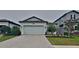 Charming single-Gathering home featuring a paved driveway and well-maintained landscaping at 20092 Stone Pine Cir, Lutz, FL 33558