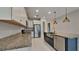 This spacious kitchen offers granite counters, stainless appliances, and island sink with modern pendant lighting at 20092 Stone Pine Cir, Lutz, FL 33558