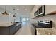 Modern kitchen design with stainless appliances, island sink, and granite countertops at 20092 Stone Pine Cir, Lutz, FL 33558