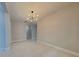 Bright living room with modern light fixture and stylish white tile flooring at 20092 Stone Pine Cir, Lutz, FL 33558