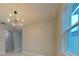 A spacious living room features an updated light fixture and bright windows at 20092 Stone Pine Cir, Lutz, FL 33558