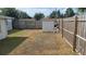 Fenced backyard features a shed, offering storage space and privacy at 2035 Erin Dr, Holiday, FL 34690