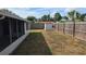 Well-maintained backyard featuring a privacy fence, storage shed, and ample space for outdoor activities and gardening at 2035 Erin Dr, Holiday, FL 34690
