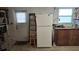 Basement includes a fridge and ladder by the back door at 2035 Erin Dr, Holiday, FL 34690