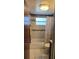 View of bathroom showcasing a tub with tiled walls, a window, and a toilet at 2035 Erin Dr, Holiday, FL 34690