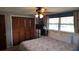 Bedroom with a comfortable bed, closet with wood-paneled doors, and natural light at 2035 Erin Dr, Holiday, FL 34690