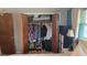 Walk-in closet with organized storage solutions, including clothing racks, shoe storage, and shelving at 2035 Erin Dr, Holiday, FL 34690