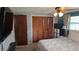 Bedroom closet with wood-paneled doors open to reveal the closet's storage options at 2035 Erin Dr, Holiday, FL 34690
