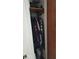 Small closet with hanging clothes and cleaning equipment, including a vacuum cleaner at 2035 Erin Dr, Holiday, FL 34690