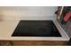 Close-up of a sleek, black electric cooktop set into a light-colored countertop at 2035 Erin Dr, Holiday, FL 34690