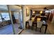 Dining room with a wooden table and chairs, leading to a screened lanai with a bike at 2035 Erin Dr, Holiday, FL 34690