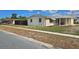 Cozy single-story home featuring stone accents and a covered porch, complemented by a well-maintained landscape at 2035 Erin Dr, Holiday, FL 34690