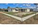 A cozy single-story home featuring stone accents, a covered porch, and a well-kept yard at 2035 Erin Dr, Holiday, FL 34690