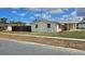 A quaint, one-story house with stone accents and awnings, featuring a well-maintained exterior at 2035 Erin Dr, Holiday, FL 34690