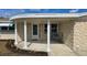 Inviting covered front porch with stylish support columns and outdoor seating area at 2035 Erin Dr, Holiday, FL 34690