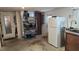 Spacious garage area equipped with a second refrigerator, shelving, and visible laundry connections at 2035 Erin Dr, Holiday, FL 34690