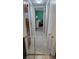 Hallway with tile flooring and safety gates, leading to various rooms in the house at 2035 Erin Dr, Holiday, FL 34690