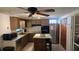 Kitchen featuring wood cabinets, stainless steel appliances, and a kitchen island with a butcher block top at 2035 Erin Dr, Holiday, FL 34690