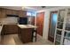 Kitchen featuring wood cabinets, stainless steel appliances, and a kitchen island with seating at 2035 Erin Dr, Holiday, FL 34690