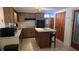 Kitchen featuring wood cabinets, stainless steel appliances, and a kitchen island with butcher block top at 2035 Erin Dr, Holiday, FL 34690
