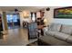 Living room with glass sliding doors leading to a covered patio and views of the backyard at 2035 Erin Dr, Holiday, FL 34690