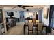 Open living area with dining table, chairs, and a comfortable sitting area with a TV at 2035 Erin Dr, Holiday, FL 34690