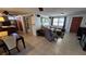 Living room featuring tile floors, a sofa, armchairs, and a dining table with chairs at 2035 Erin Dr, Holiday, FL 34690