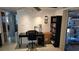 Office setup featuring a black desk, chair, and shelving, adjacent to a sliding glass door at 2035 Erin Dr, Holiday, FL 34690