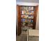 Well-organized pantry with wooden louvered doors, filled with an array of food items and supplies at 2035 Erin Dr, Holiday, FL 34690
