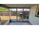 View of screened porch with grill and view of the fenced backyard at 2035 Erin Dr, Holiday, FL 34690