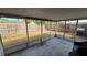 Large screened patio with outdoor seating and a clear view of the backyard at 2035 Erin Dr, Holiday, FL 34690