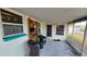 Inviting screened porch with seating and views of the fenced backyard at 2035 Erin Dr, Holiday, FL 34690