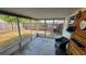 Enjoy outdoor living in the enclosed screened patio with backyard view at 2035 Erin Dr, Holiday, FL 34690