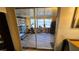 Bright sun room with work out equipment, storage shelving and a sliding door at 2035 Erin Dr, Holiday, FL 34690