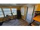 Tiled sun room with work out equipment, large windows and an exterior door at 2035 Erin Dr, Holiday, FL 34690