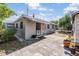 Charming backyard featuring a cozy home exterior, complemented by a paved patio at 2111 W Grace St, Tampa, FL 33607