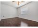 Bedroom with dark wood floors, white walls, a ceiling fan and a window at 2111 W Grace St, Tampa, FL 33607