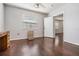 Bedroom with dark wood floors, white walls, a ceiling fan and a window at 2111 W Grace St, Tampa, FL 33607