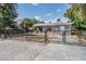 Cozy home with chain-link fence, a well-maintained lawn, and a concrete driveway at 2111 W Grace St, Tampa, FL 33607