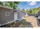 Home exterior featuring a side yard and inviting entrance at 2111 W Grace St, Tampa, FL 33607