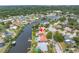 A high aerial view of a waterfront home with solar panels, a pool and dock at 2146 Egret Drive, Clearwater, FL 33764