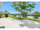 Beautiful backyard featuring lush green lawn and canal view with a private dock at 2146 Egret Drive, Clearwater, FL 33764