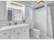 Bathroom featuring a white vanity, shower with white tiling and brushed gold fixtures at 2146 Egret Drive, Clearwater, FL 33764