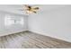 Sun-filled bedroom features hardwood flooring and a ceiling fan at 2146 Egret Drive, Clearwater, FL 33764